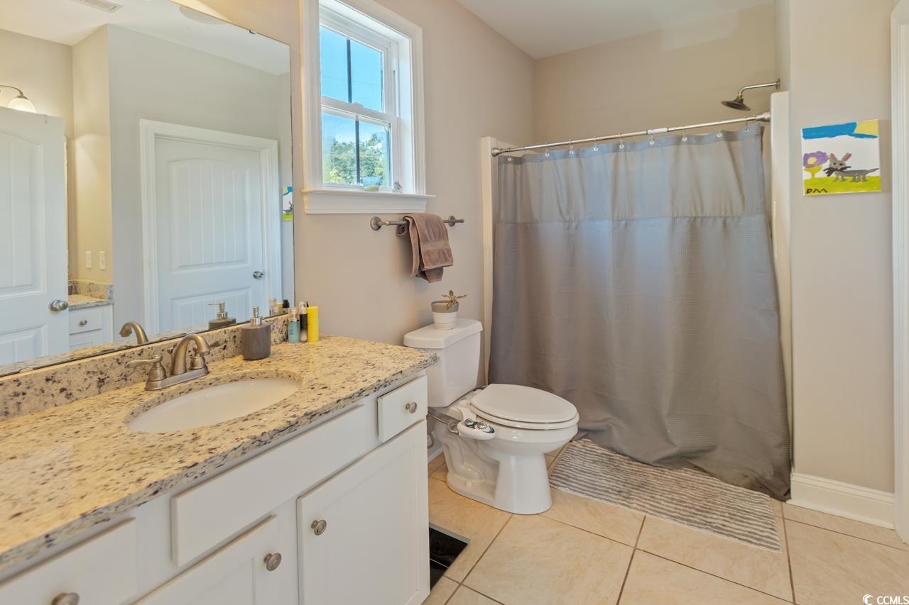 3887 Spanner Way Murrells Inlet, SC 29576 - Photo 17 of 32 Bathroom with vanity, light tile patterned flooring, and a shower with curtain