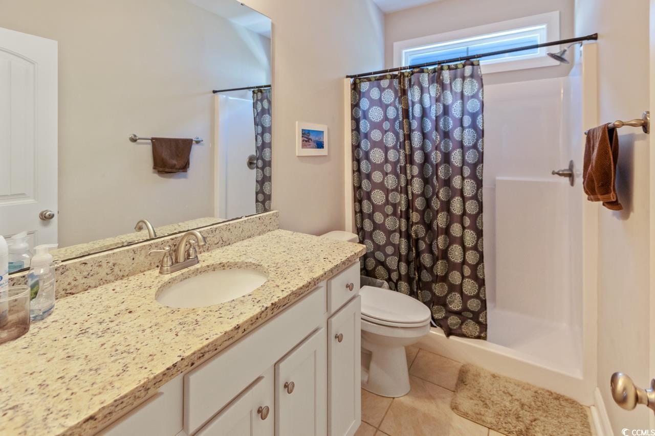 3887 Spanner Way Murrells Inlet, SC 29576 - Photo 25 of 32 Full bathroom featuring vanity, a stall shower, and light tile patterned floors