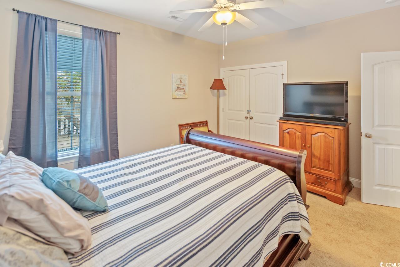 3887 Spanner Way Murrells Inlet, SC 29576 - Photo 27 of 32 Bedroom featuring light carpet, a ceiling fan, and a closet