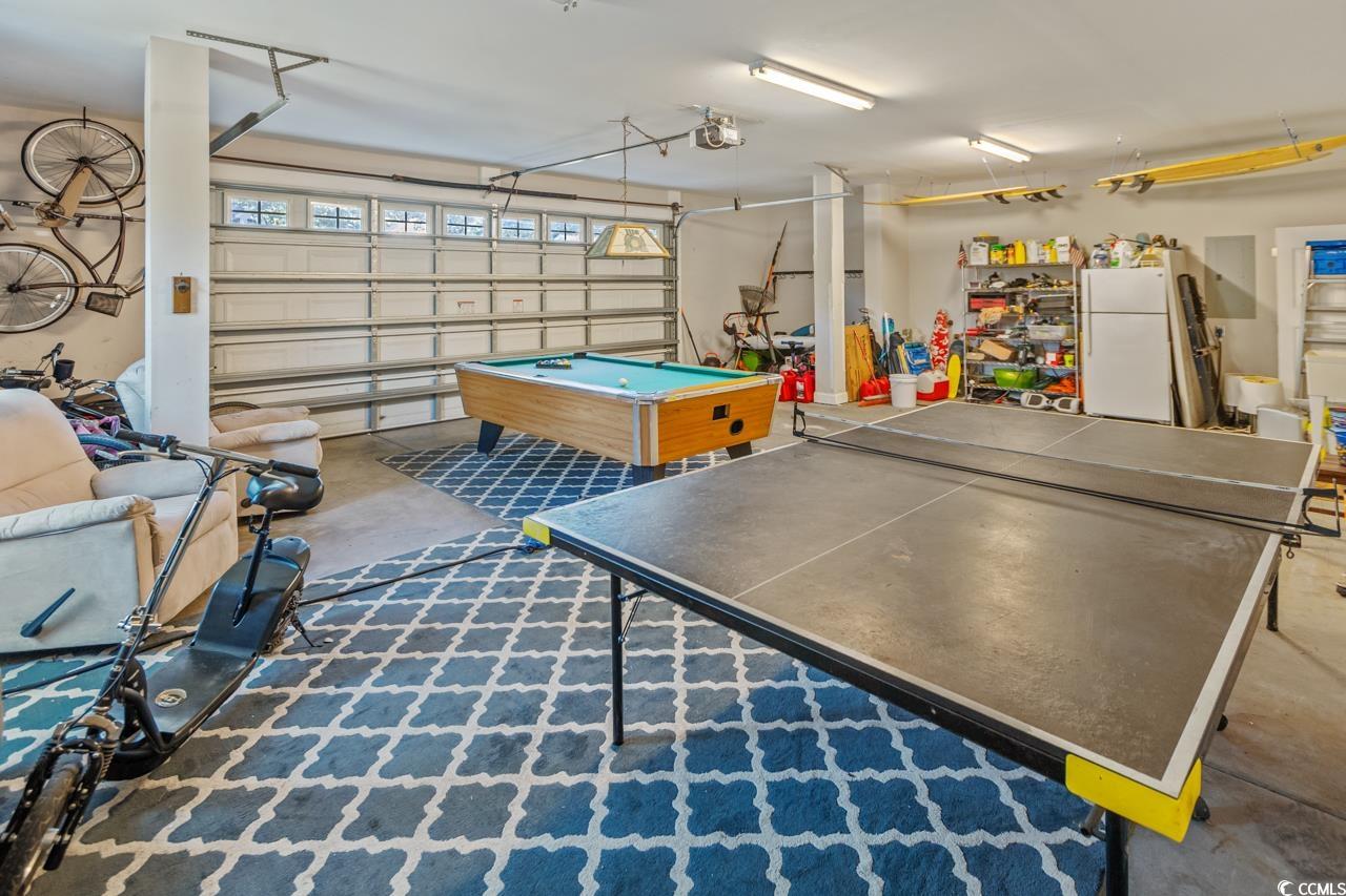 3887 Spanner Way Murrells Inlet, SC 29576 - Photo 28 of 32 Rec room featuring a garage, concrete flooring, and billiards