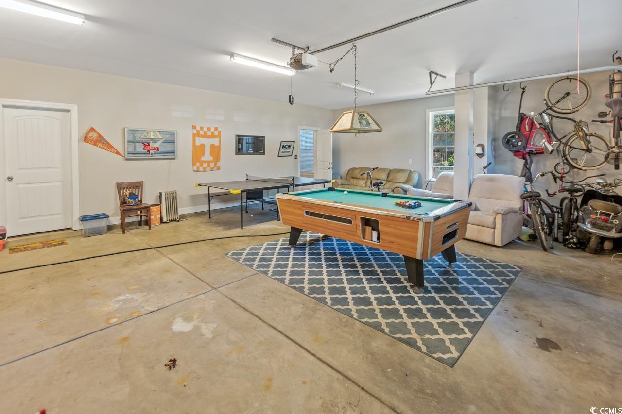 3887 Spanner Way Murrells Inlet, SC 29576 - Photo 29 of 32 Rec room featuring a garage, billiards table, concrete floors, and radiator heating unit