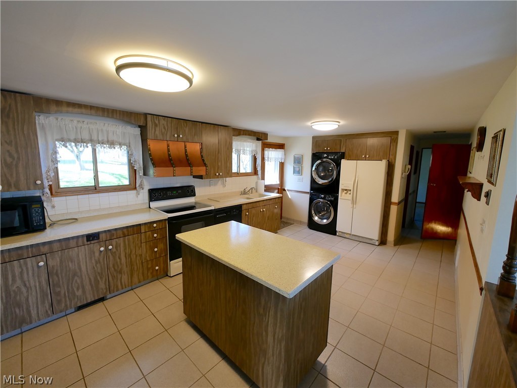 57500 Hospital Road Bellaire, OH 43906 - Photo 21 of 22 Kitchen with stacked washer / drying machine, fume extractor, white appliances, and a wealth of natural light