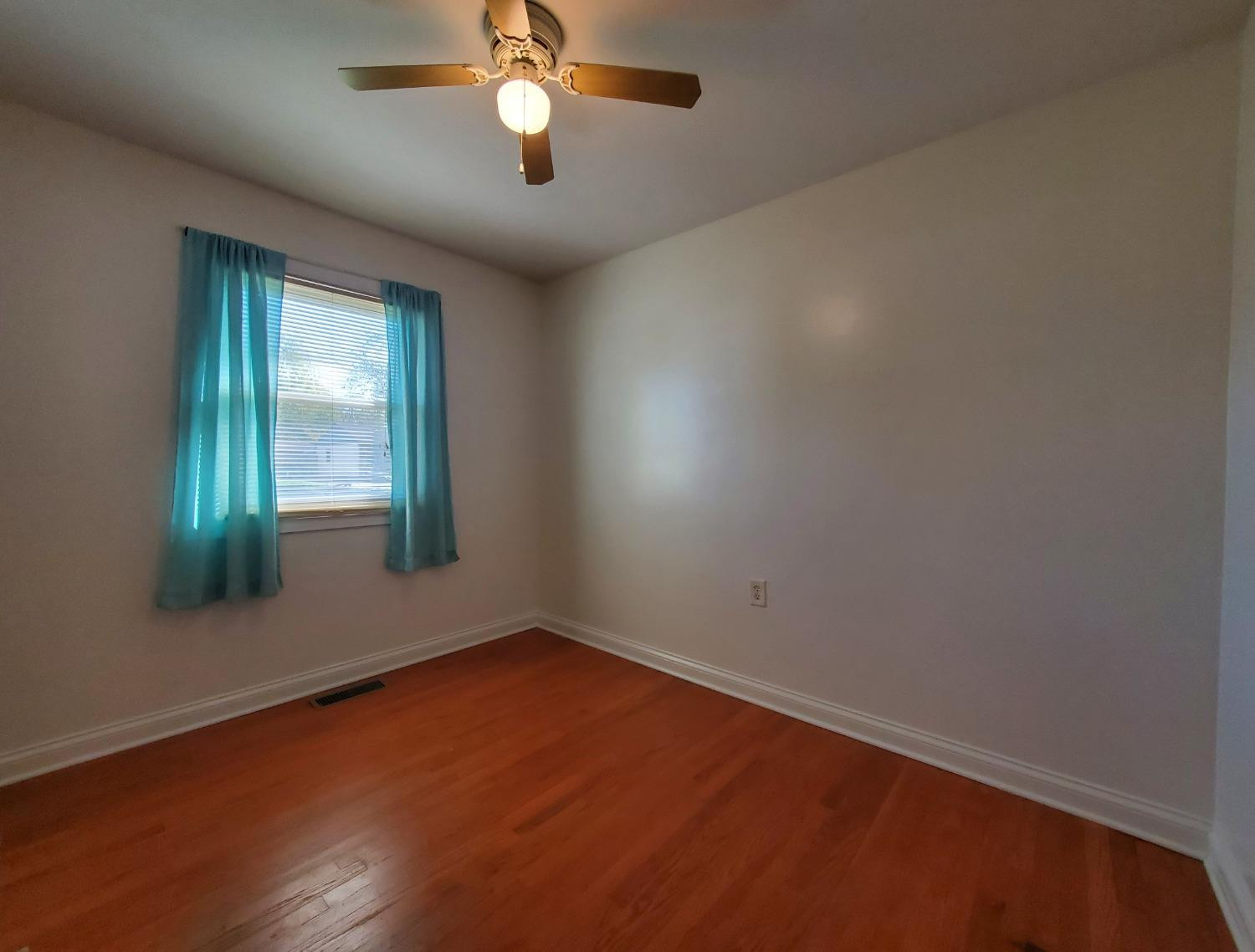 722 Fremont Road Valparaiso, IN 46385 - Photo 13 of 17 an empty room with wooden floor and windows