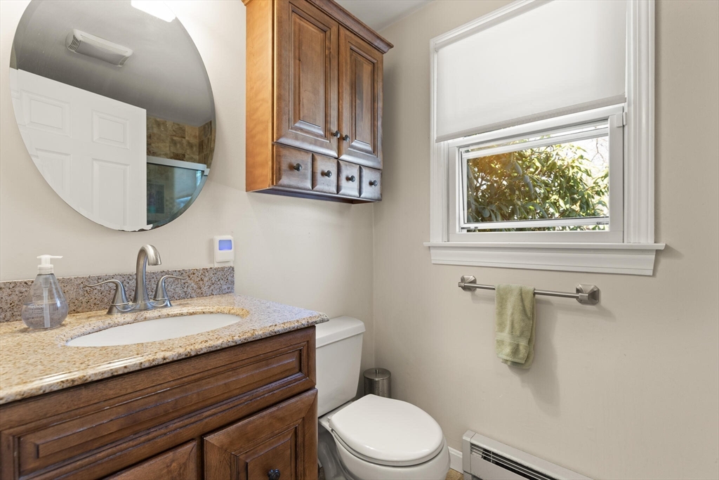 552 Hudson Road Sudbury, MA 01776 - Photo 13 of 19 a bathroom with a granite countertop toilet sink and mirror