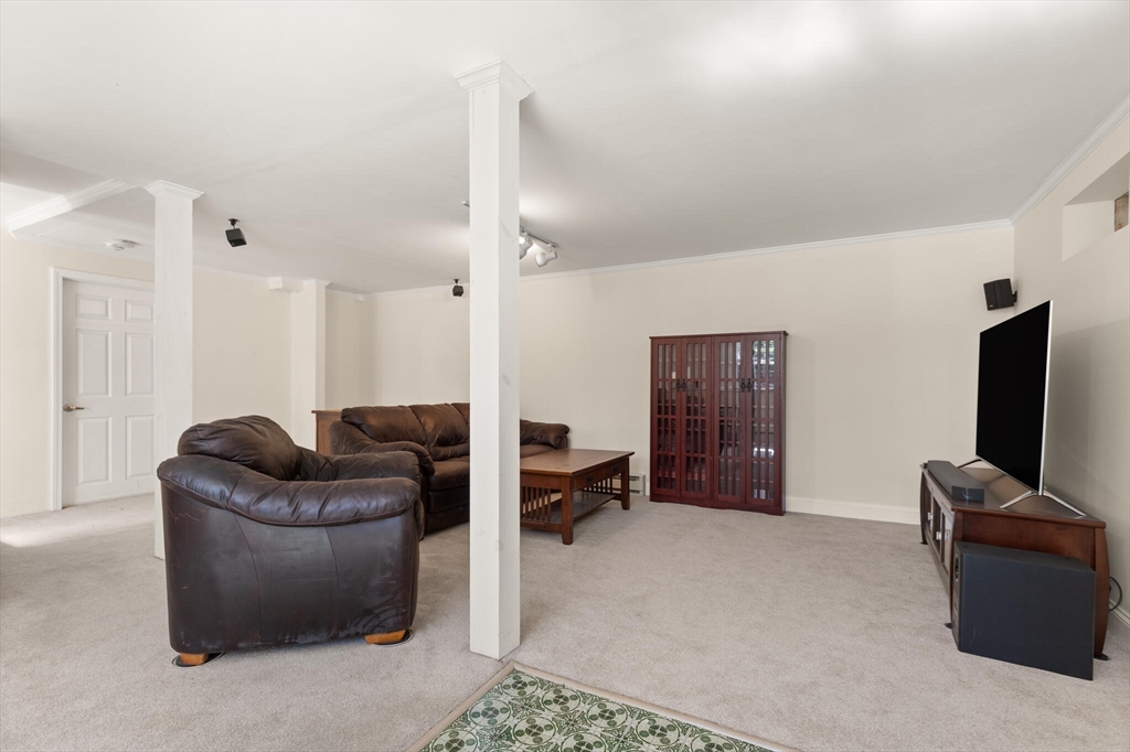 552 Hudson Road Sudbury, MA 01776 - Photo 16 of 19 a living room with furniture and a flat screen tv