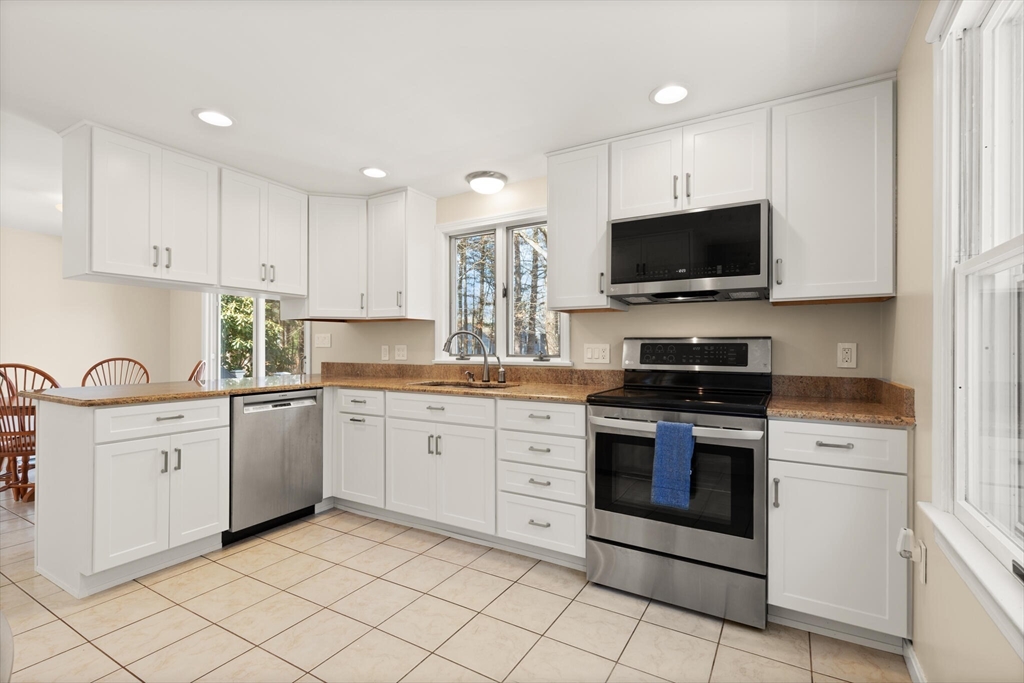 552 Hudson Road Sudbury, MA 01776 - Photo 6 of 19 a kitchen with granite countertop white cabinets stainless steel appliances and a sink