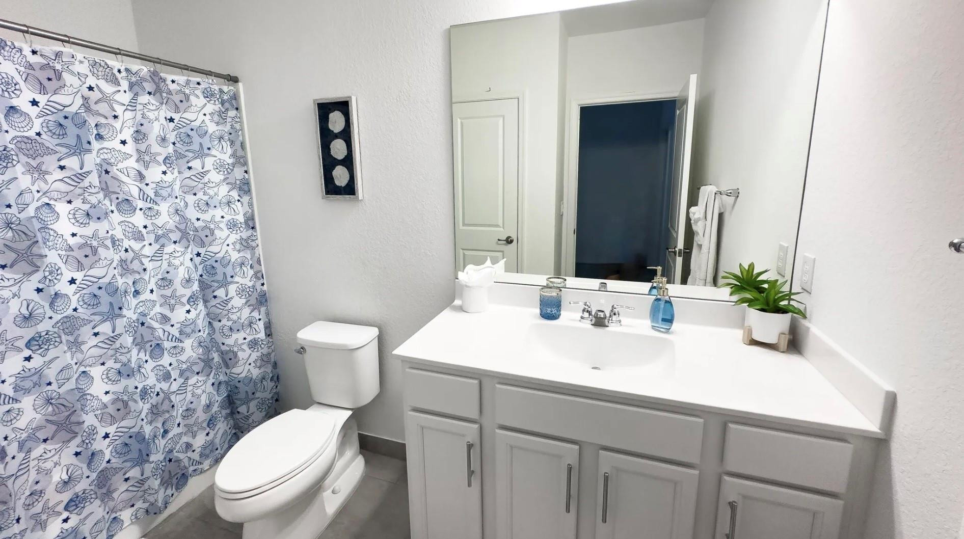 5114 Armina Place Fort Pierce, FL 34951 - Photo 11 of 28 a bathroom with a sink a toilet and mirror