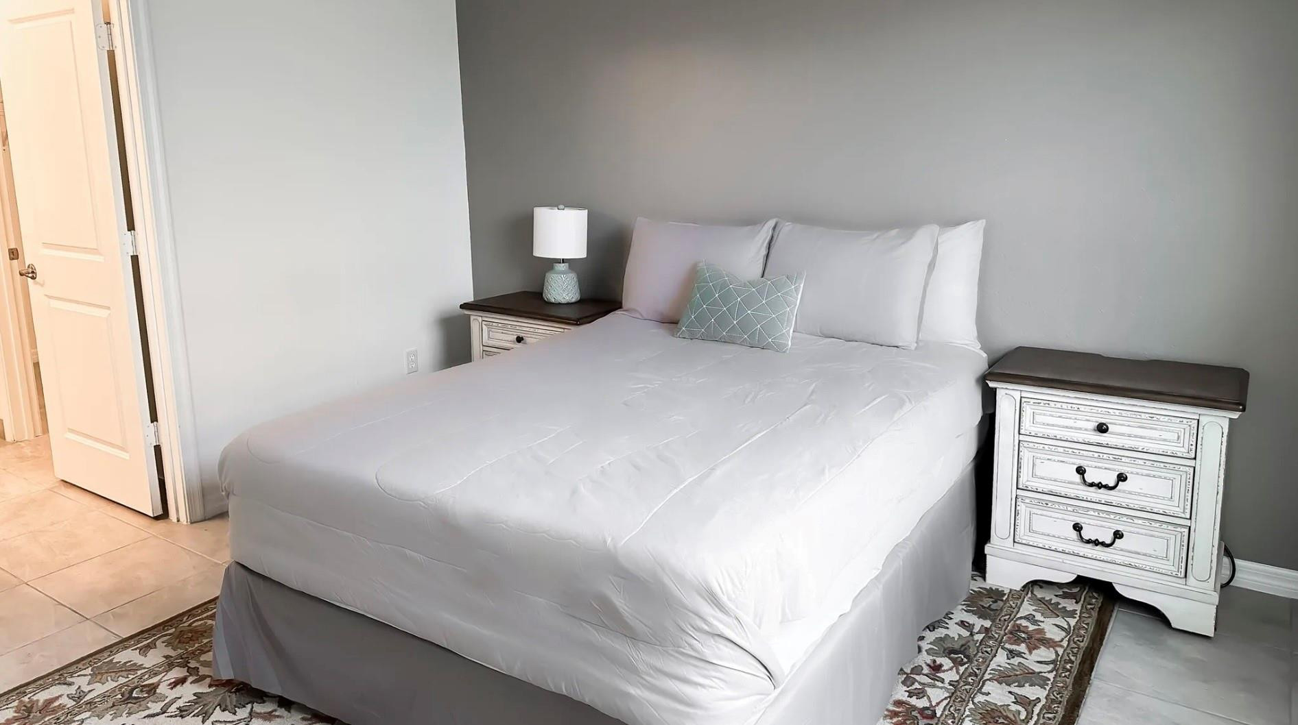 5114 Armina Place Fort Pierce, FL 34951 - Photo 16 of 28 a bedroom with a bed and a mirror