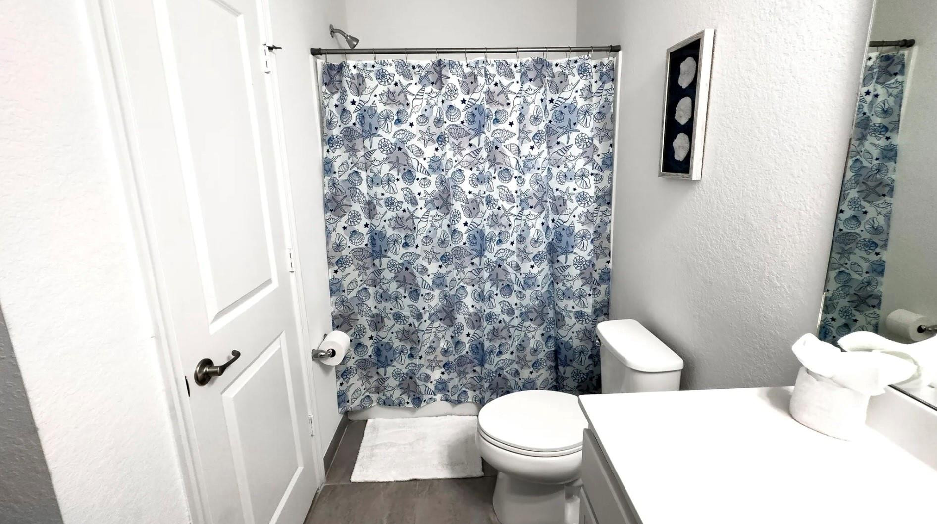 5114 Armina Place Fort Pierce, FL 34951 - Photo 10 of 28 a a bathroom with a toilet and a shower curtain