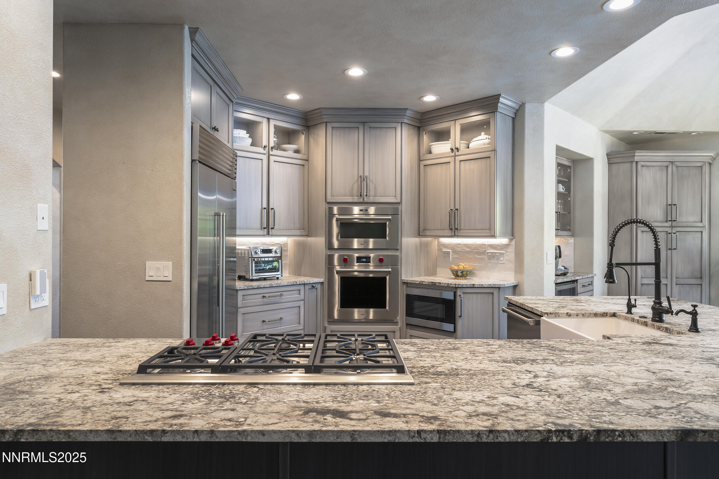 1762 Belford Road Reno, NV 89509 - Photo 11 of 70 a kitchen with kitchen island granite countertop a stove and cabinets