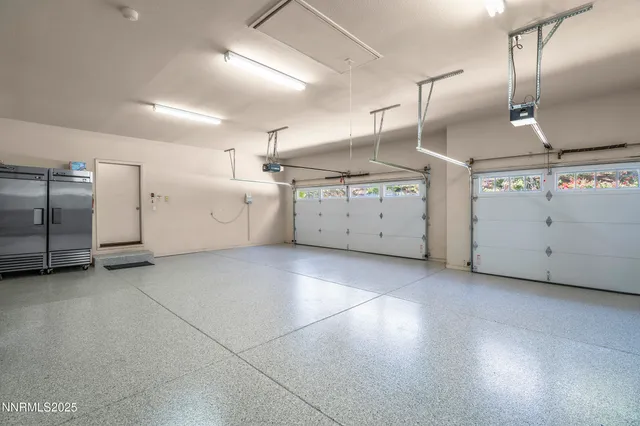 a view of a patio with table and chairs under an umbrella