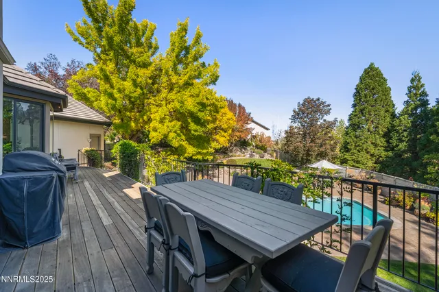 a view of a patio with a table and chairs under an umbrella