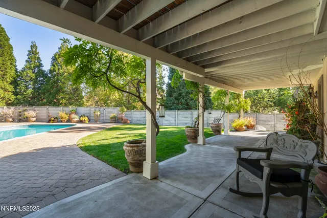 a view of a backyard with plants and a patio