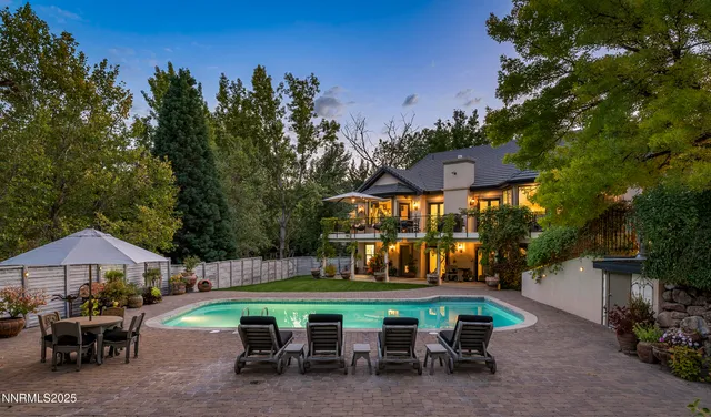 an outdoor space with pool and furniture
