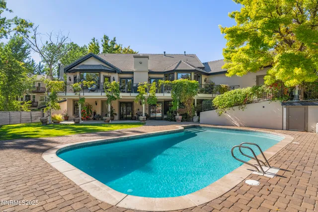 an aerial view of a house with a yard basket ball court and outdoor seating