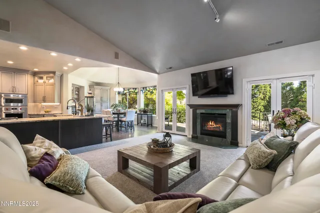 a living room with furniture and a chandelier