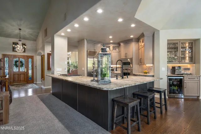a kitchen with kitchen island granite countertop a stove and cabinets