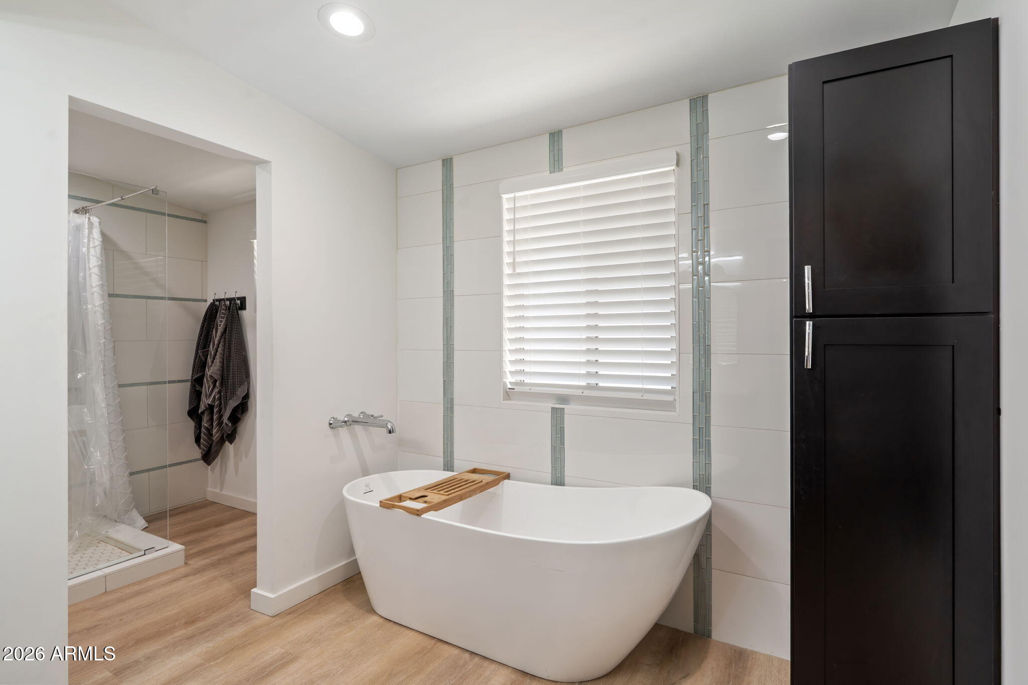 3901 North 19th Street Phoenix, AZ 85016 - Photo 11 of 20 a spacious bathroom with a bathtub and next to a window
