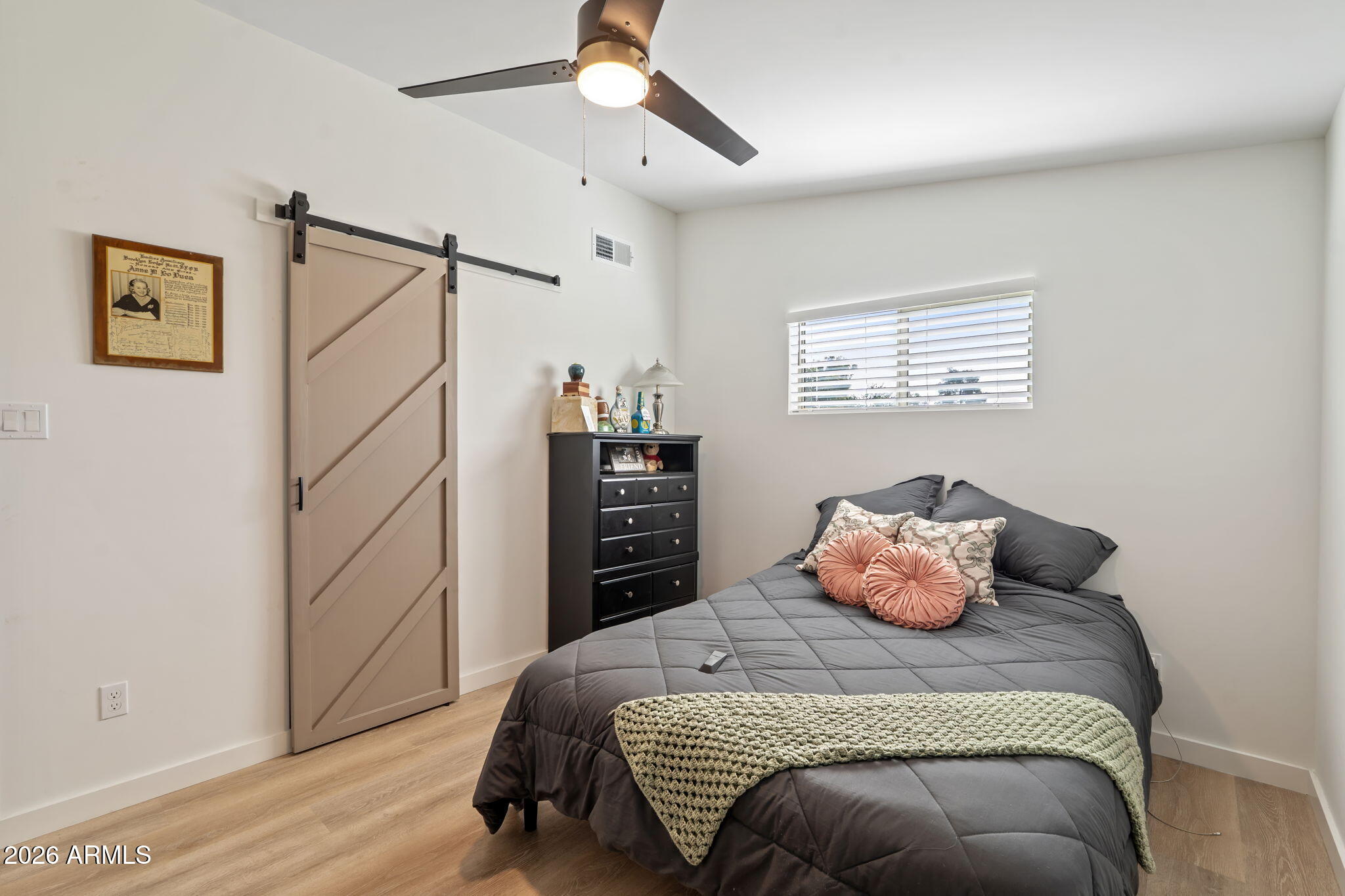 3901 North 19th Street Phoenix, AZ 85016 - Photo 15 of 20 a bedroom with a bed and wooden floor