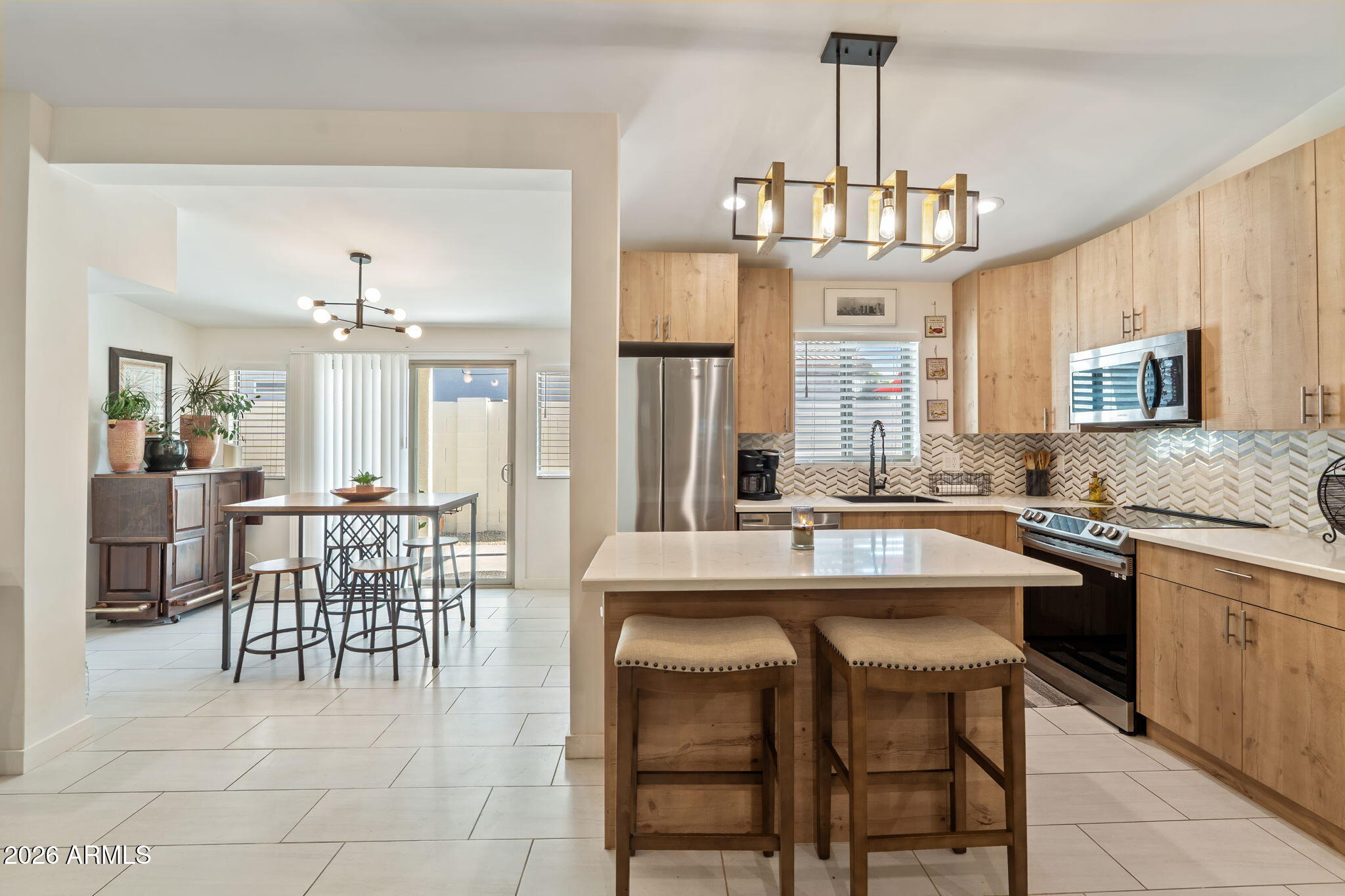 3901 North 19th Street Phoenix, AZ 85016 - Photo 5 of 20 a kitchen with a dining table chairs sink and granite counter tops