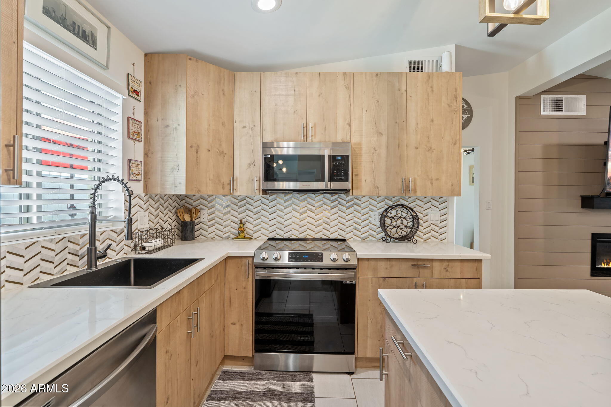 3901 North 19th Street Phoenix, AZ 85016 - Photo 7 of 20 a kitchen with stainless steel appliances a stove sink and cabinets