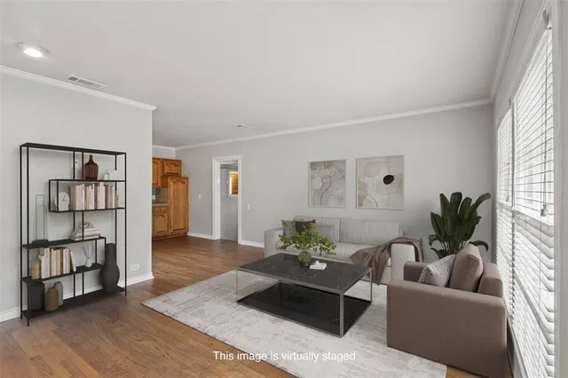 a living room with furniture and wooden floor