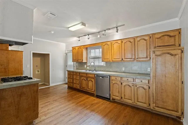 a kitchen with stainless steel appliances granite countertop a stove a sink and a refrigerator
