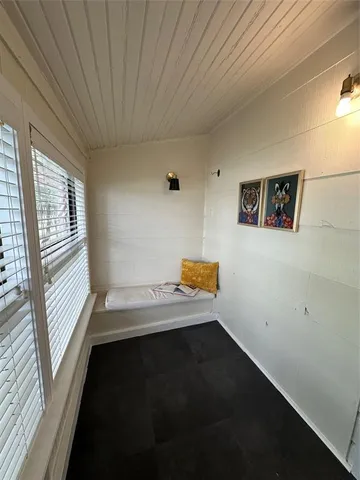 a room with a wooden floor and a window
