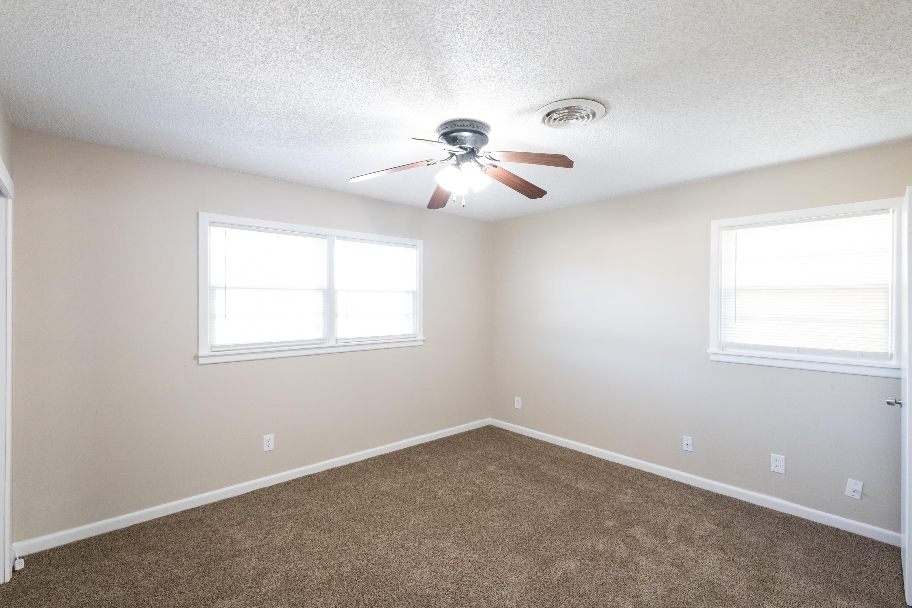 5323 31st Street Lubbock, TX 79407 - Photo 12 of 28 a view of a room with a ceiling fan and window
