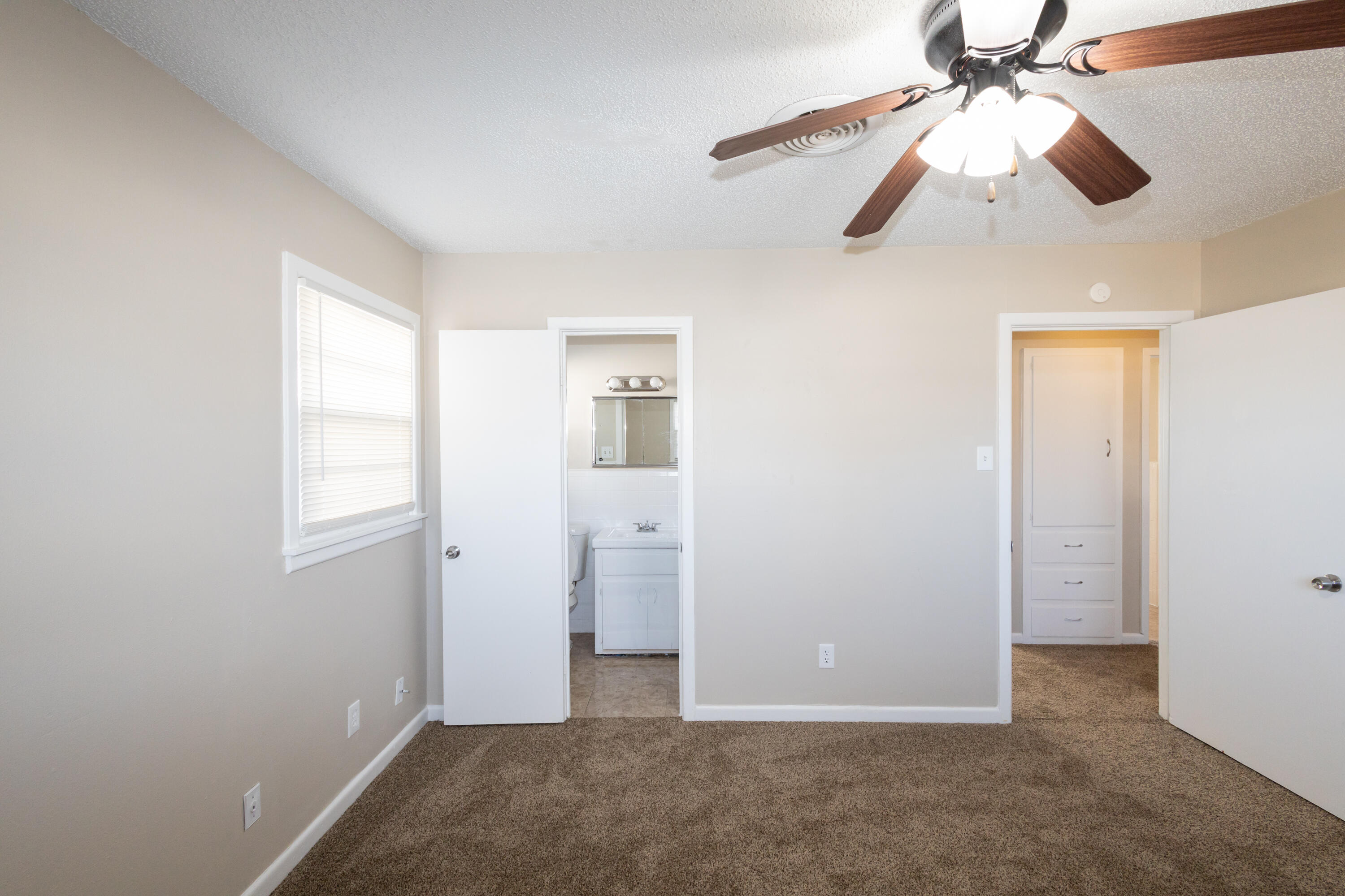 5323 31st Street Lubbock, TX 79407 - Photo 14 of 28 an empty room with closet and a chandelier fan