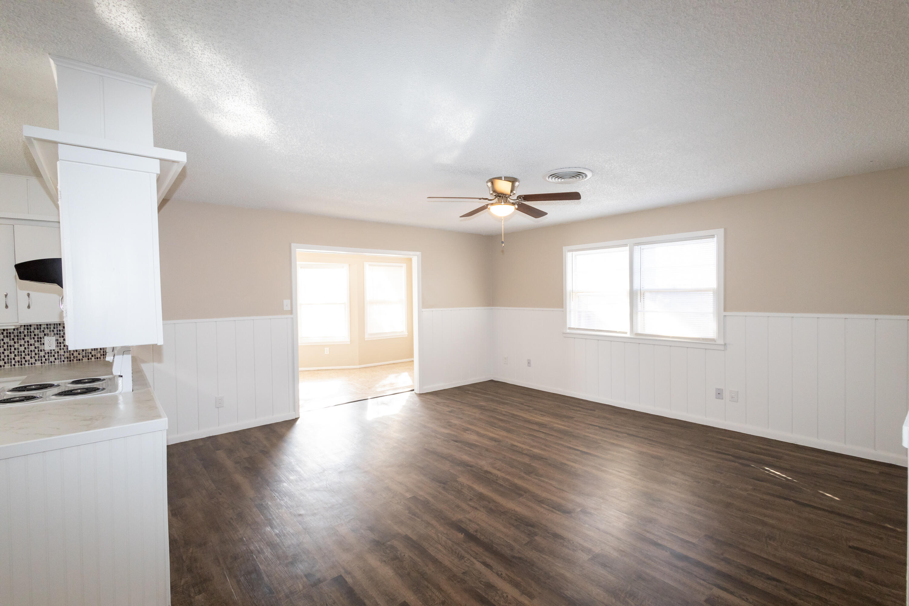 5323 31st Street Lubbock, TX 79407 - Photo 4 of 28 an empty room with wooden floor and windows