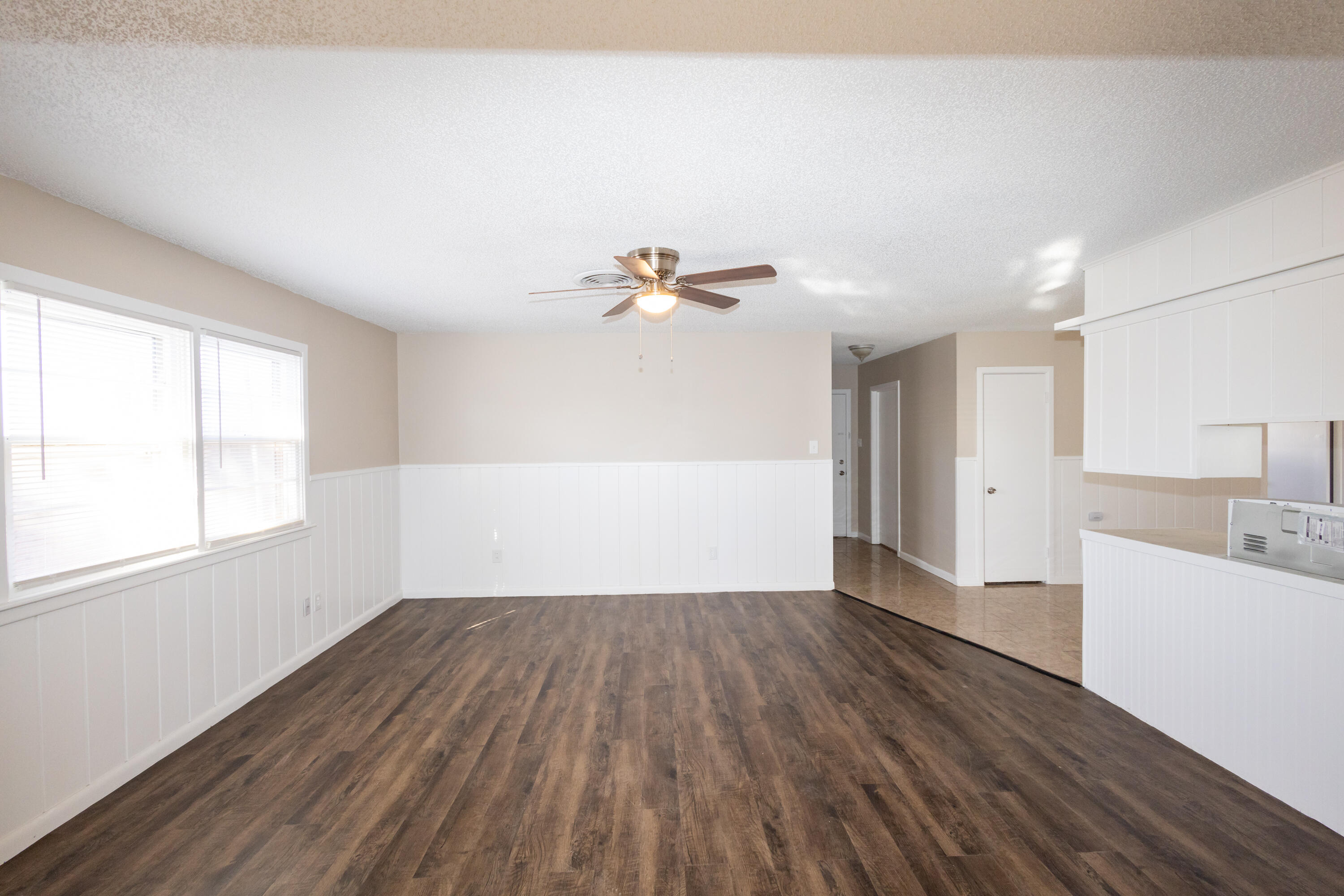 5323 31st Street Lubbock, TX 79407 - Photo 6 of 28 an empty room with wooden floor and windows