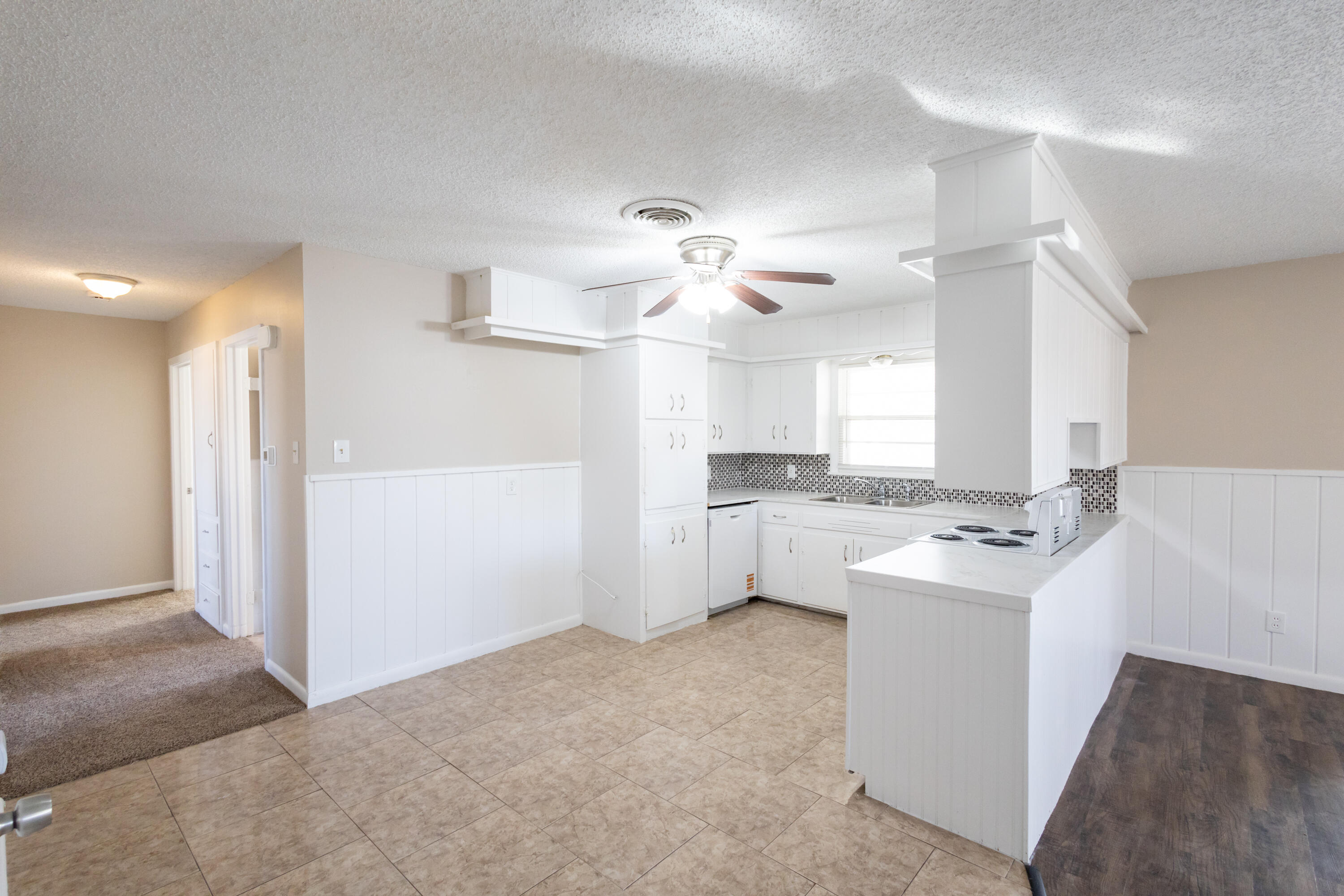 5323 31st Street Lubbock, TX 79407 - Photo 7 of 28 a open kitchen with cabinets a stove and a fireplace