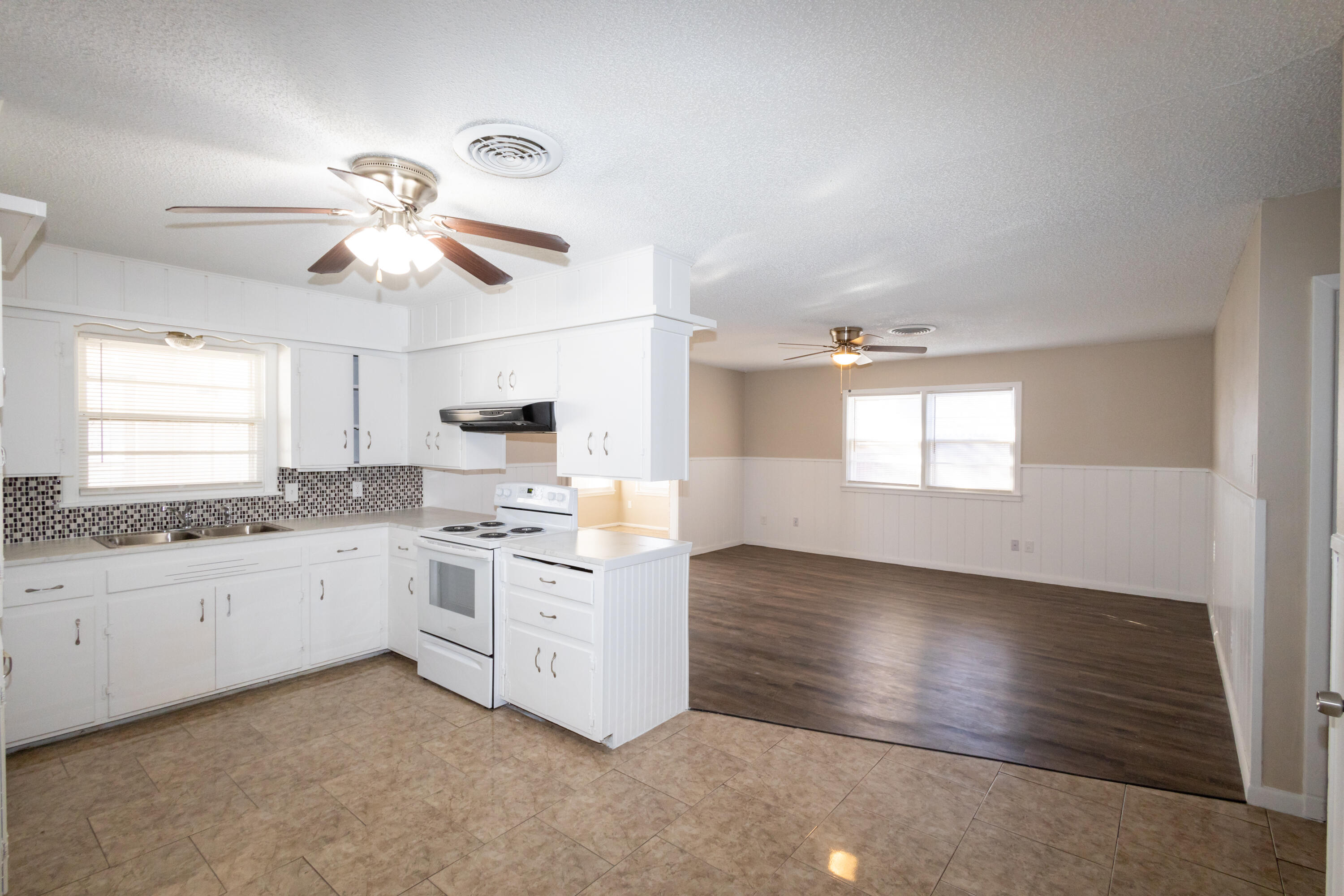 5323 31st Street Lubbock, TX 79407 - Photo 9 of 28 a kitchen with granite countertop white cabinets and white appliances