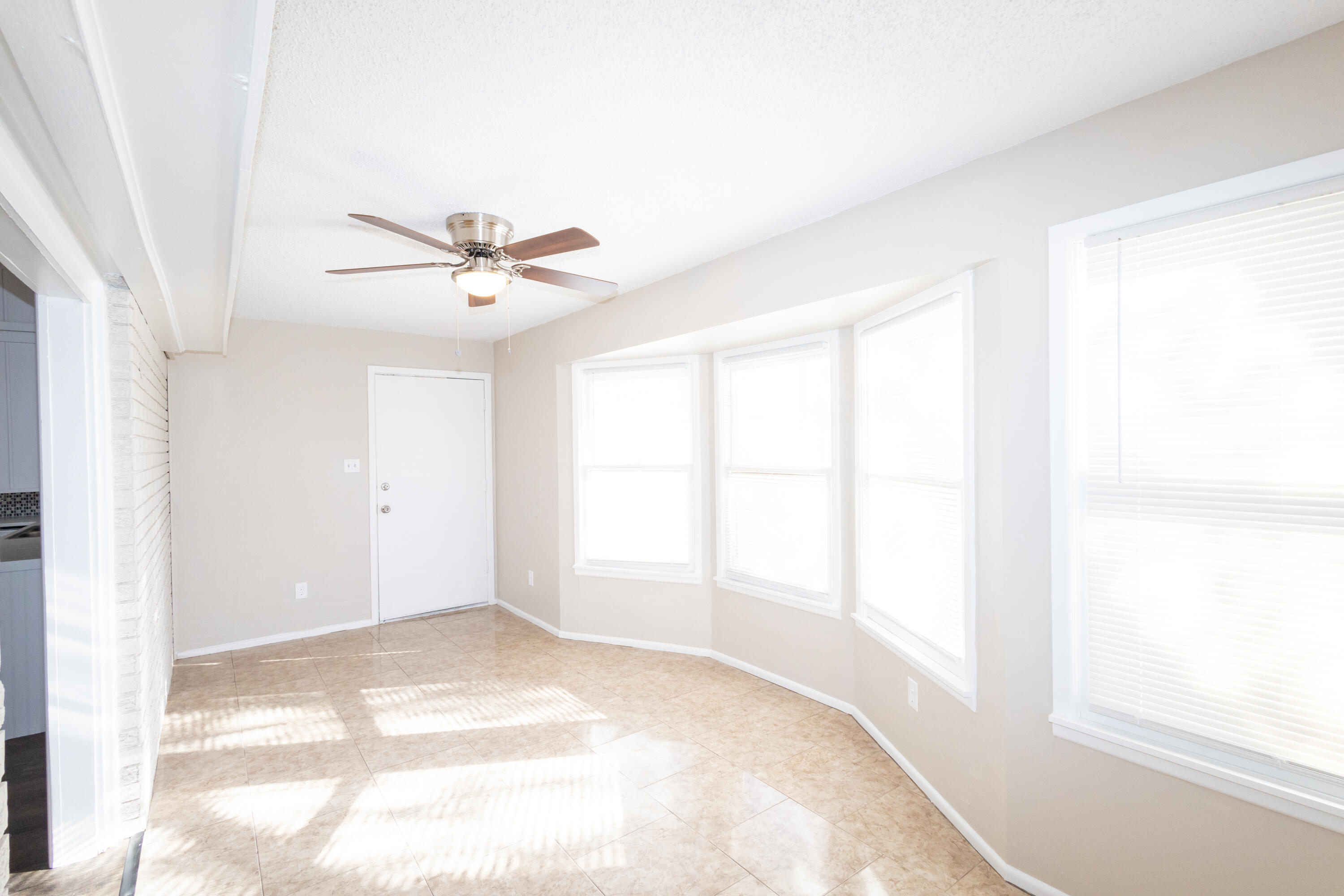 5323 31st Street Lubbock, TX 79407 - Photo 10 of 28 an empty room with a window and a ceiling fan