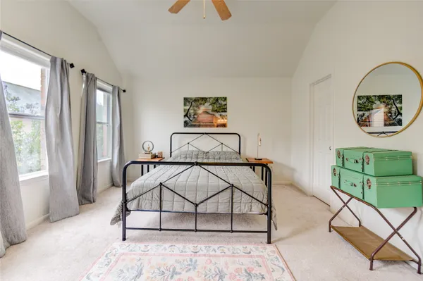 a view of a bedroom with furniture and window