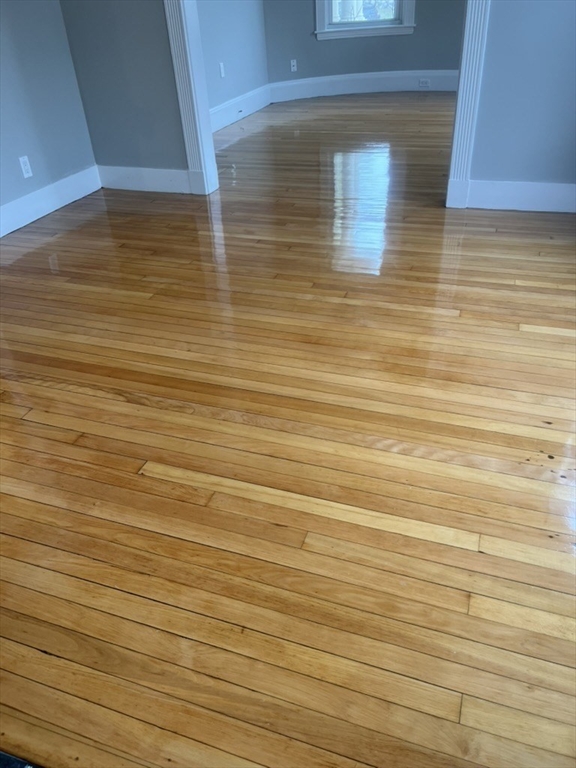 168 Brook Road, Unit 1 Milton, MA 02186 - Photo 13 of 13 a view of empty room with wooden floor