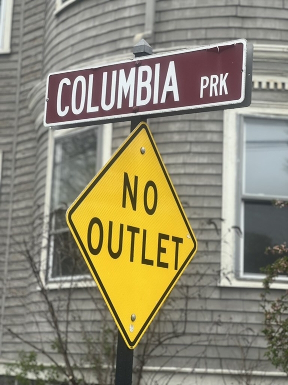 168 Brook Road, Unit 1 Milton, MA 02186 - Photo 3 of 13 a street sign that is on a pole