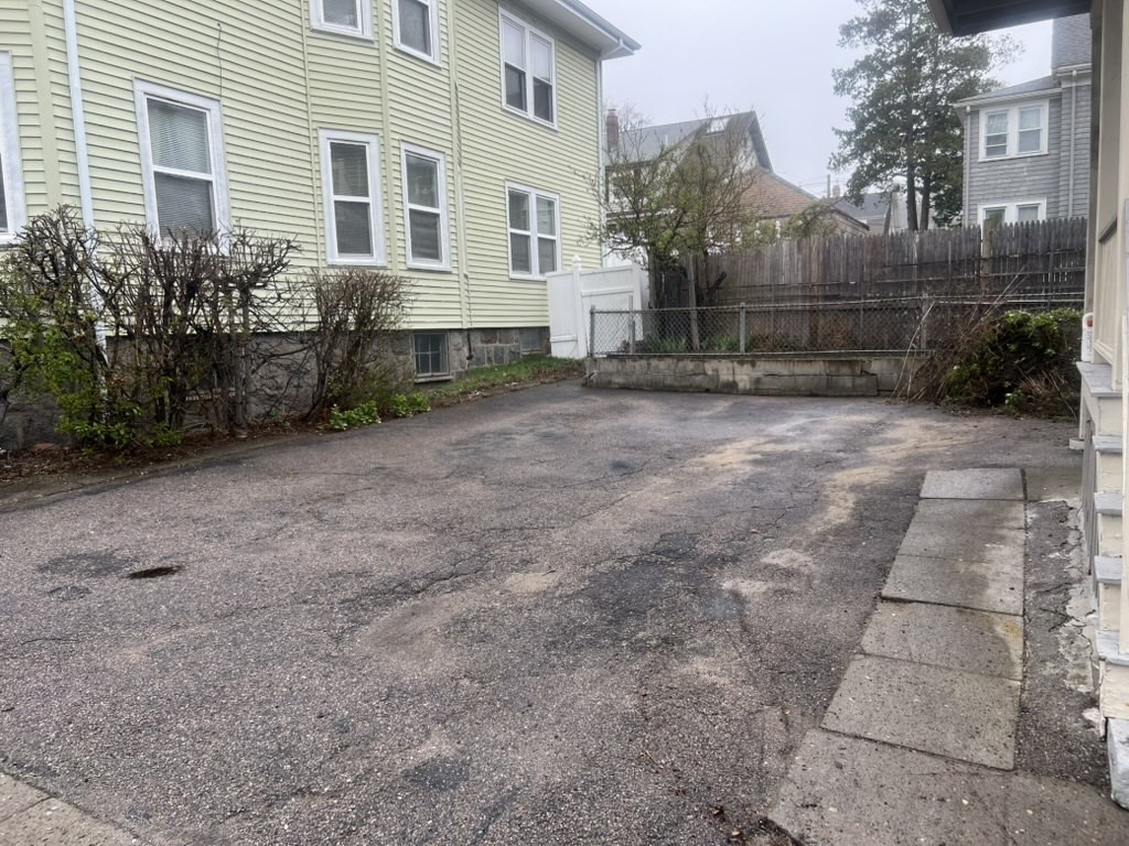 168 Brook Road, Unit 1 Milton, MA 02186 - Photo 5 of 13 a house view with a backyard