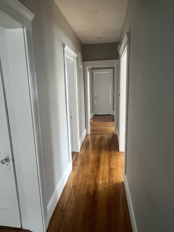 168 Brook Road, Unit 1 Milton, MA 02186 - Photo 9 of 13 a view of a hallway with wooden floor