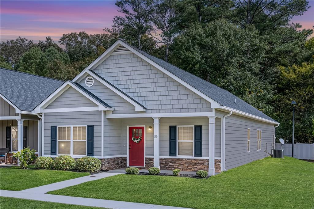 a front view of a house with a garden