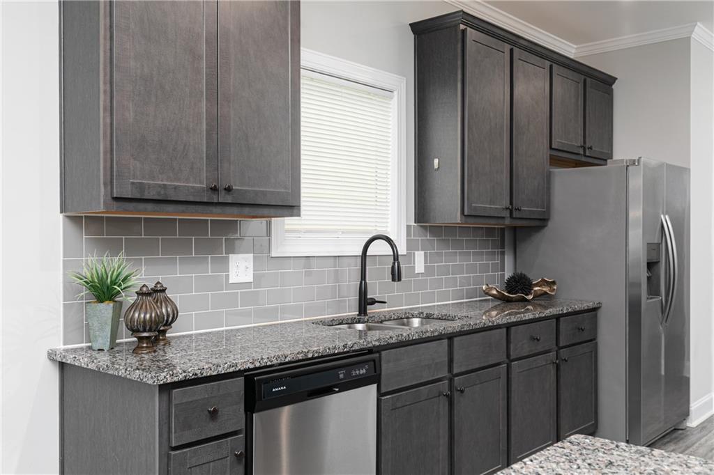 59 Calloway Lane Cartersville, GA 30120 - Photo 11 of 29 a kitchen with stainless steel appliances granite countertop a sink a refrigerator and cabinets