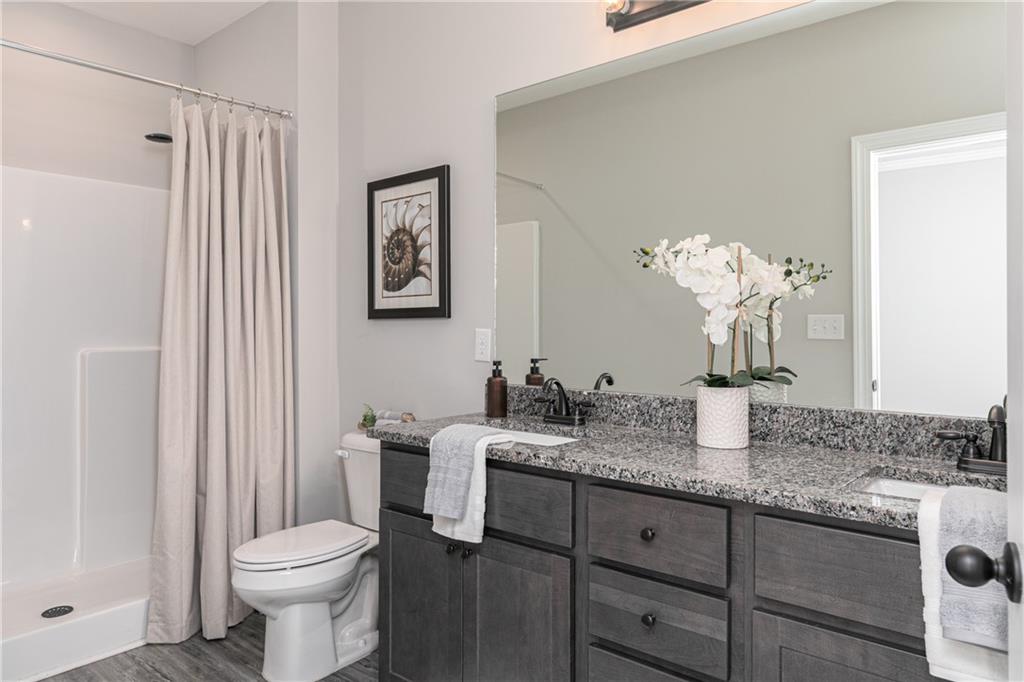59 Calloway Lane Cartersville, GA 30120 - Photo 15 of 29 a bathroom with a granite countertop sink a toilet and a mirror