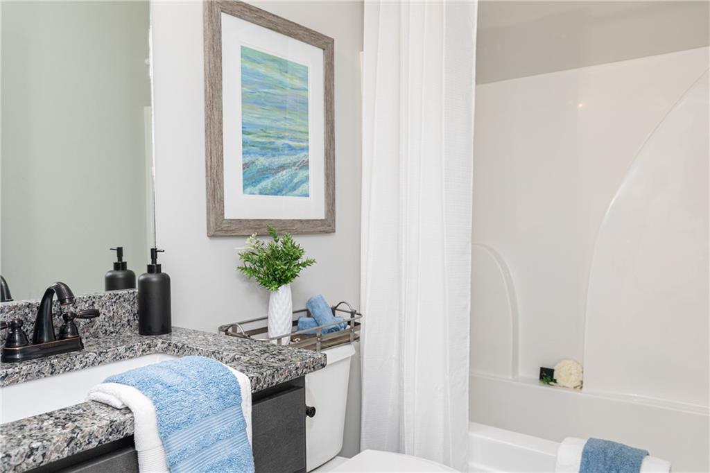 59 Calloway Lane Cartersville, GA 30120 - Photo 19 of 29 a bath room with a granite countertop sink and a mirror