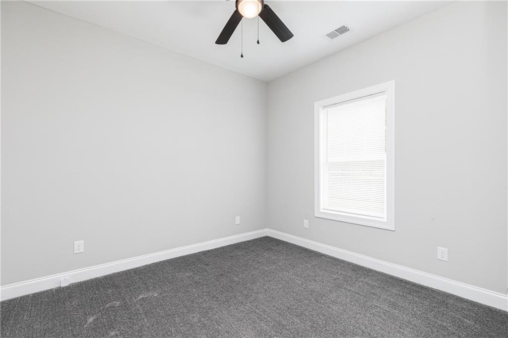 59 Calloway Lane Cartersville, GA 30120 - Photo 21 of 29 an empty room with a window and ceiling fan