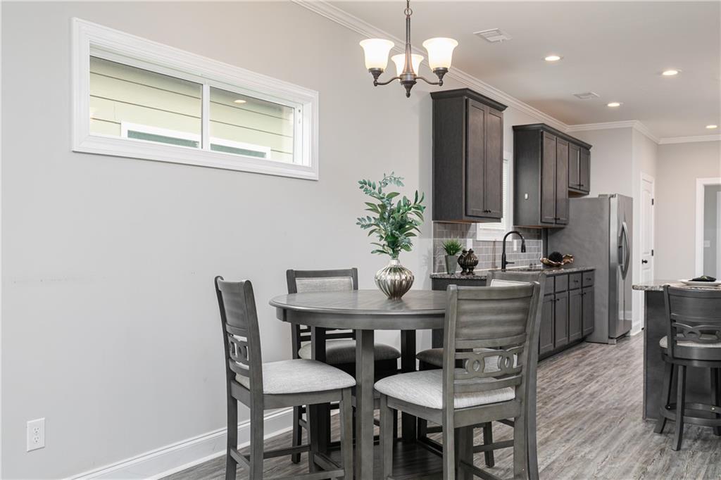 59 Calloway Lane Cartersville, GA 30120 - Photo 8 of 29 a view of a dining room with furniture a chandelier and wooden floor