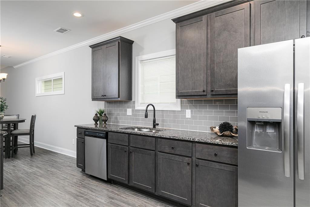 59 Calloway Lane Cartersville, GA 30120 - Photo 9 of 29 a kitchen with stainless steel appliances granite countertop a sink stove and cabinets