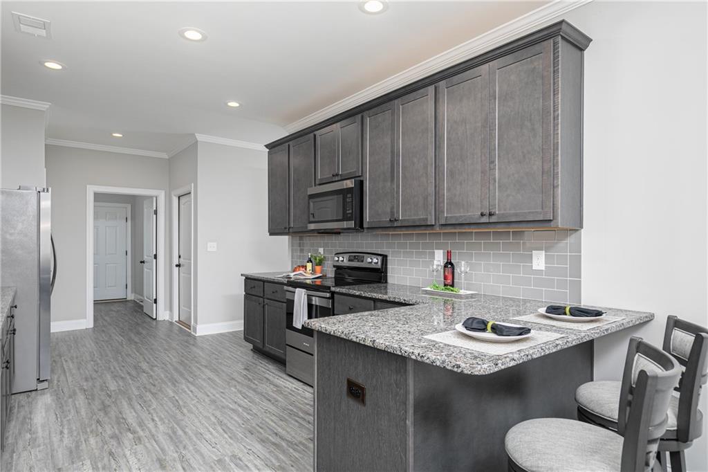 59 Calloway Lane Cartersville, GA 30120 - Photo 10 of 29 a kitchen with a sink a stove a refrigerator and cabinets