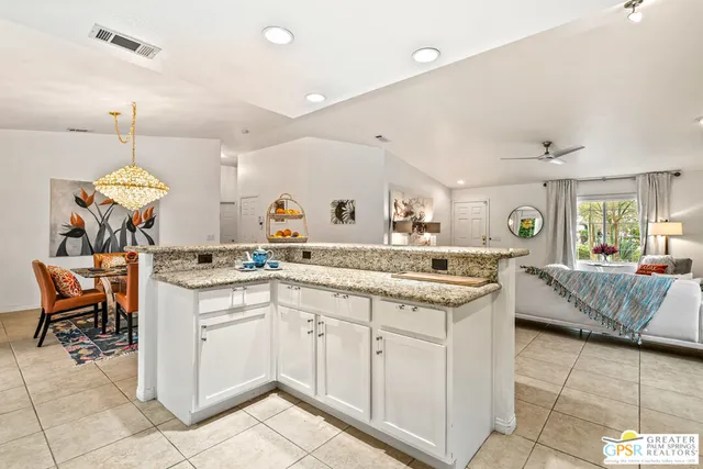 a kitchen with a sink and chairs