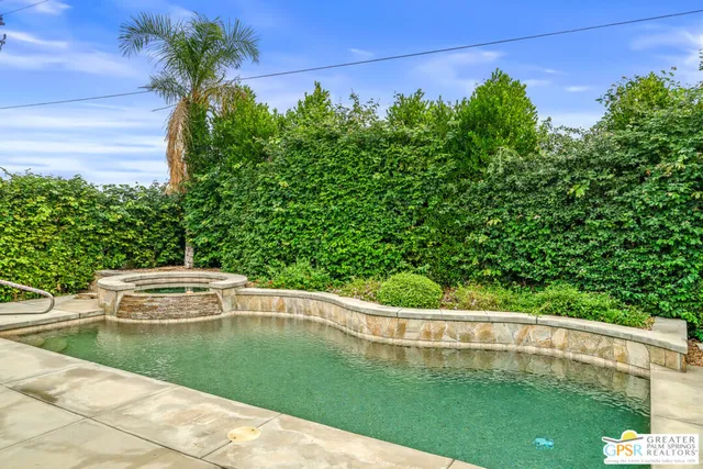 a view of a water pond with green yard
